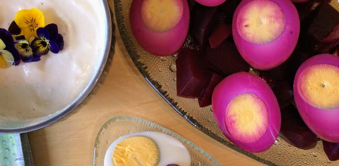 A plate of pickled eggs, hard-boiled eggs and sauce.