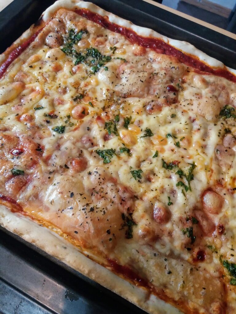 Homemade cheese pizza with cheese and parsley topping