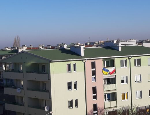 Apartment building with Ukrainian and Polish flags
